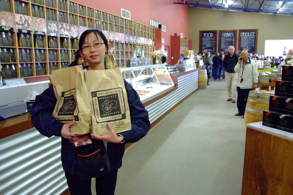 Grace carrying chocolates at the chocolate factory